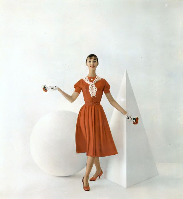 #13 Dolores Hawkins in a red Enka rayon crêpe dress by Eloise Curtis, Vogue, February 1, 1958.