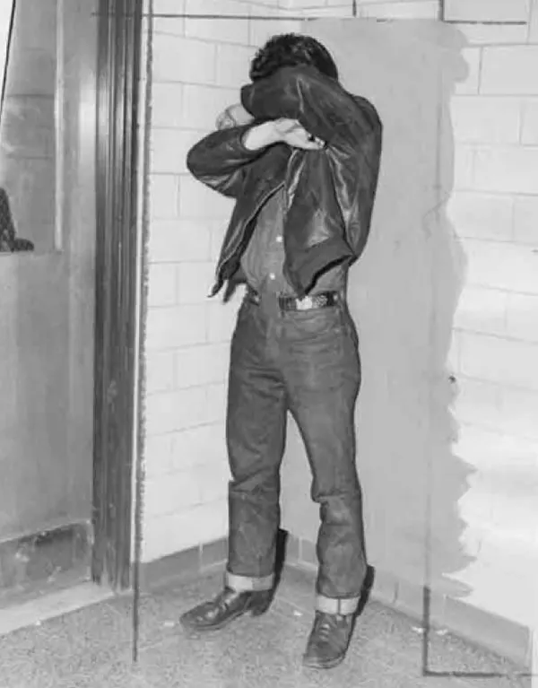 #5 Teen in 1954, hiding his face from the camera.