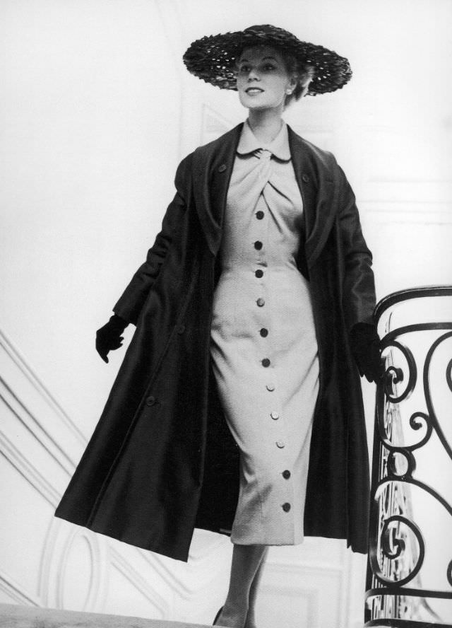 #9 Stella in a grey jersey dress and silk taffeta coat by Jacques Fath, 1953.