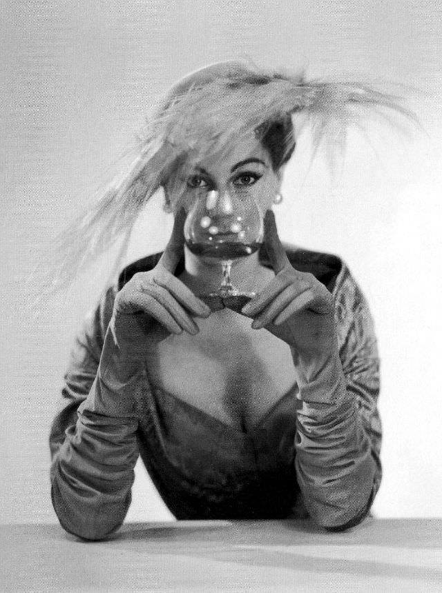 #26 Stella in a dress and feathered hat by Jacques Fath, 1955.