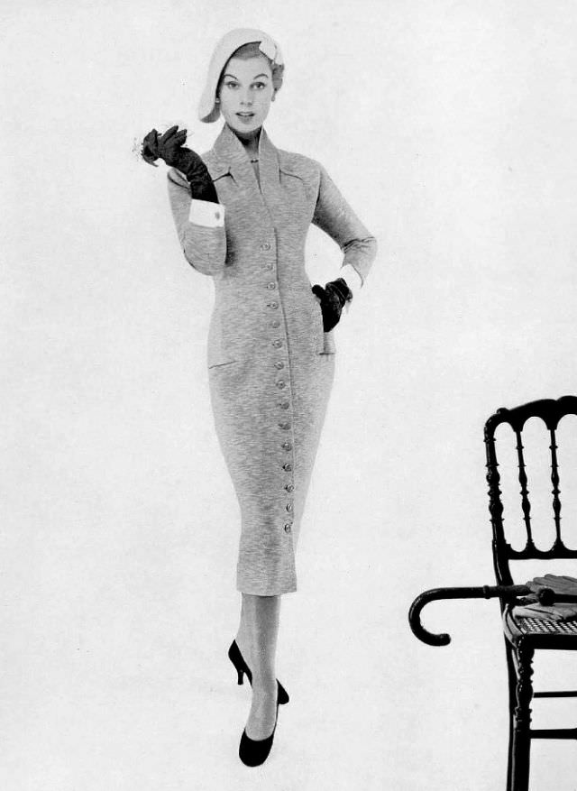 #28 Stella in a front button-through jersey sheath by Jacques Fath, 1955.