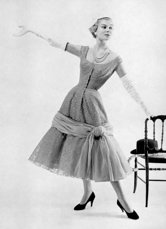 #30 Stella in a lace cocktail dress by Jacques Fath, 1955.