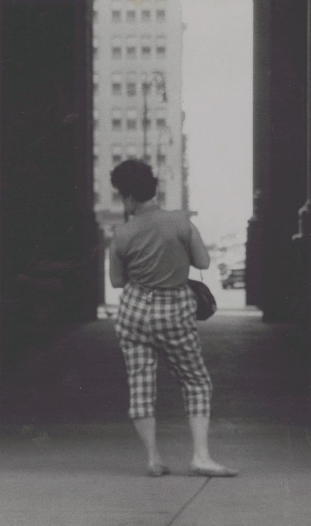 #23 View of woman standing in alleyway, full-length portrait, from behind, June 1957