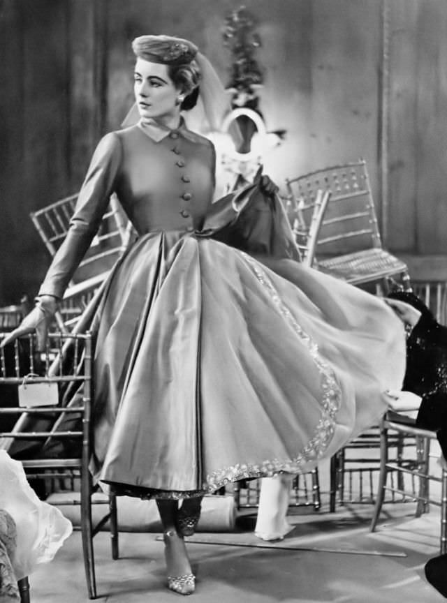 #17 Pat O’Reilly in a mushroom-pink taffeta coat by Hardy Amies, Harper’s Bazaar UK, March 1951.