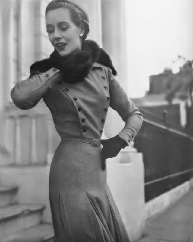 #5 Pat O’Reilly in a high-neck dress in red, brown, and white tweed by Frederick Starke, Harper’s Bazaar UK, August 1950.