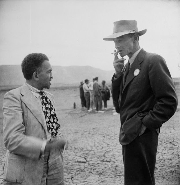 #6 J. Robert Oppenheimer speaking with New York Times reporter William Laurence at the A-bomb blast site, 1945.