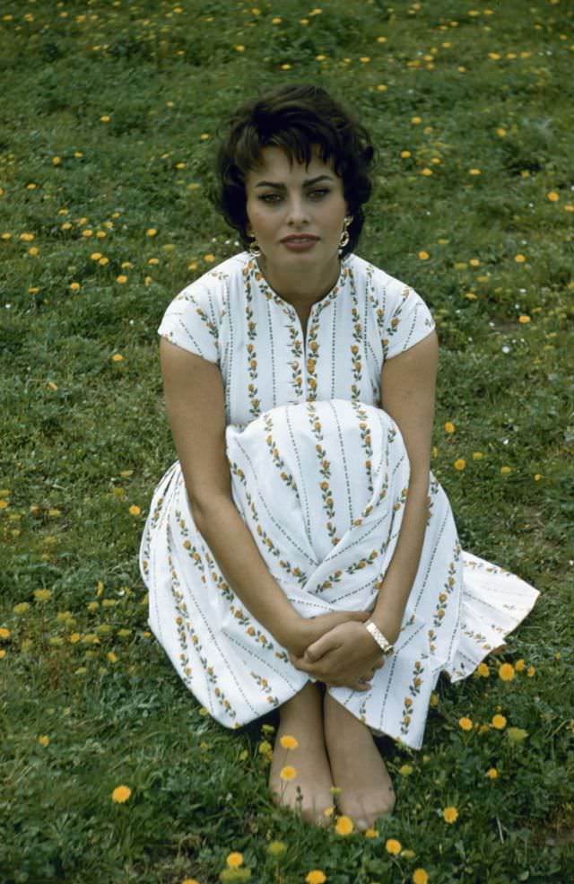 #25 Sophia Loren sitting amidst dandelions by the Via Appia Antica, Rome, Italy, 1957.