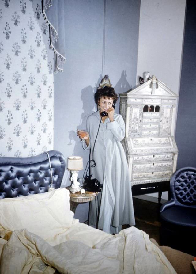 #26 Sophia Loren talking on the phone in her Rome bedroom, 1957.