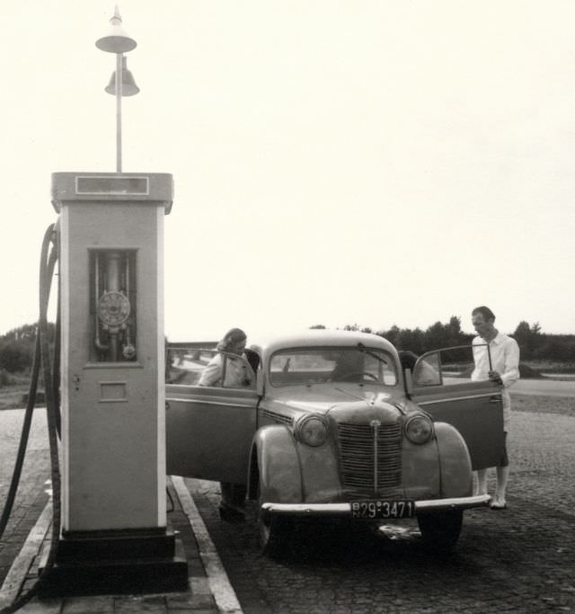 #16 People with an Opel Kadett, Syke, Lower Saxony, September 4, 1949.