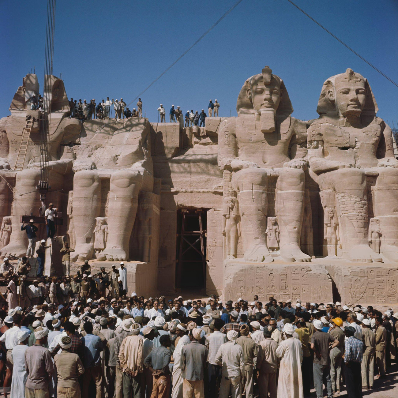 #32 Workers in front of Pharaoh Ramesses II’s statues at Abu Simbel during the 1967 reassembly after relocation to avoid Nile flooding from the Aswan High Dam.