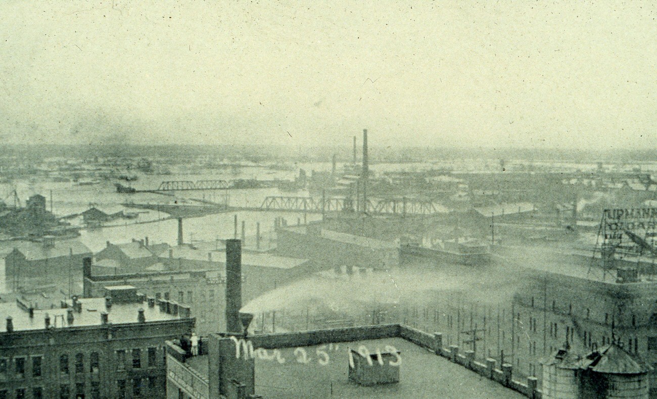 #18 Aerial view of the 1913 flood in Columbus, featuring the Charles C. Higgins Wholesale Grocery Building, March 25, 1913.