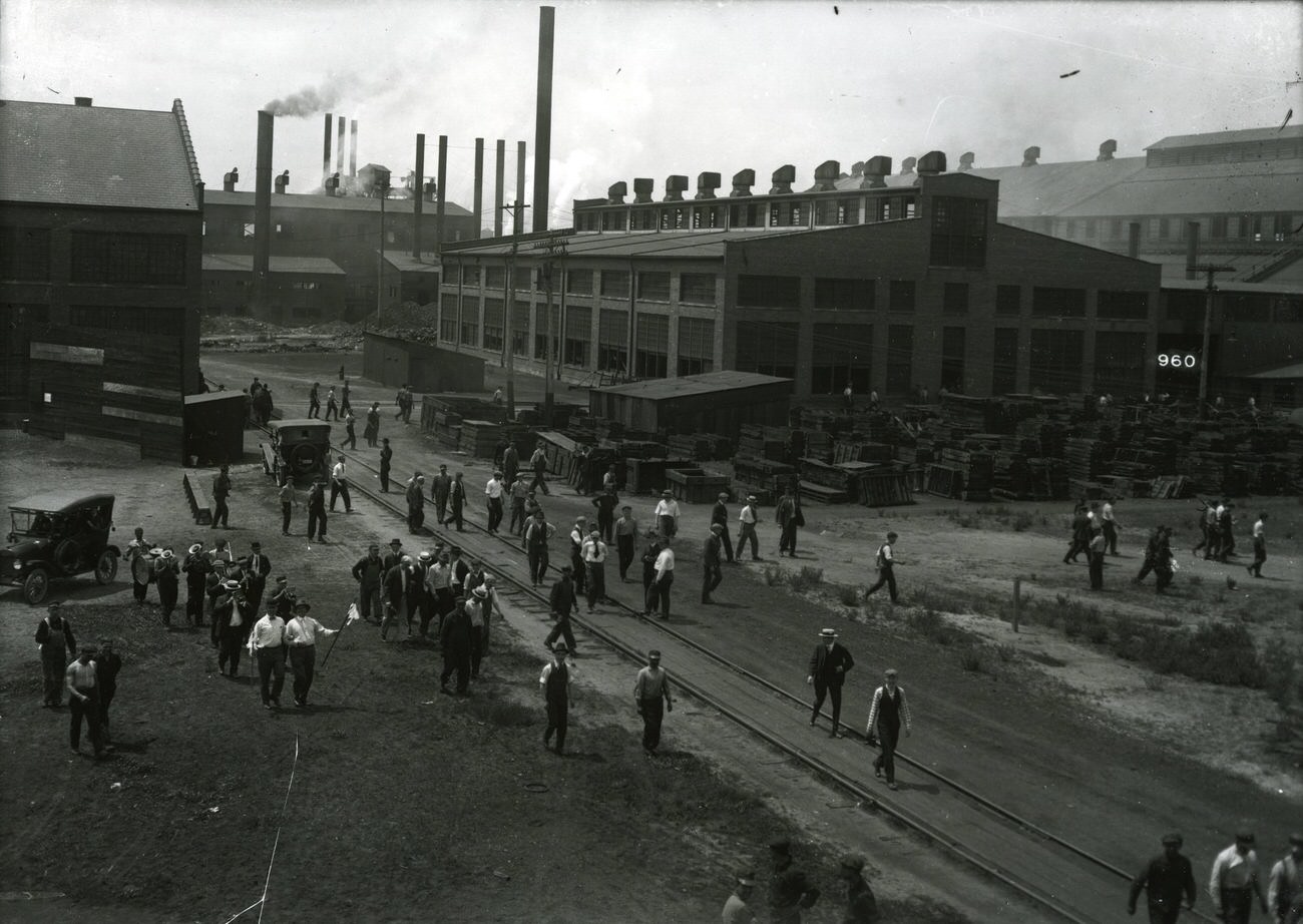 #17 Buckeye Steel yard with workers, cars, and railroad track, founded October 1902, located on Parsons Avenue, merged with Worthington Industries in 1980, circa 1920s
