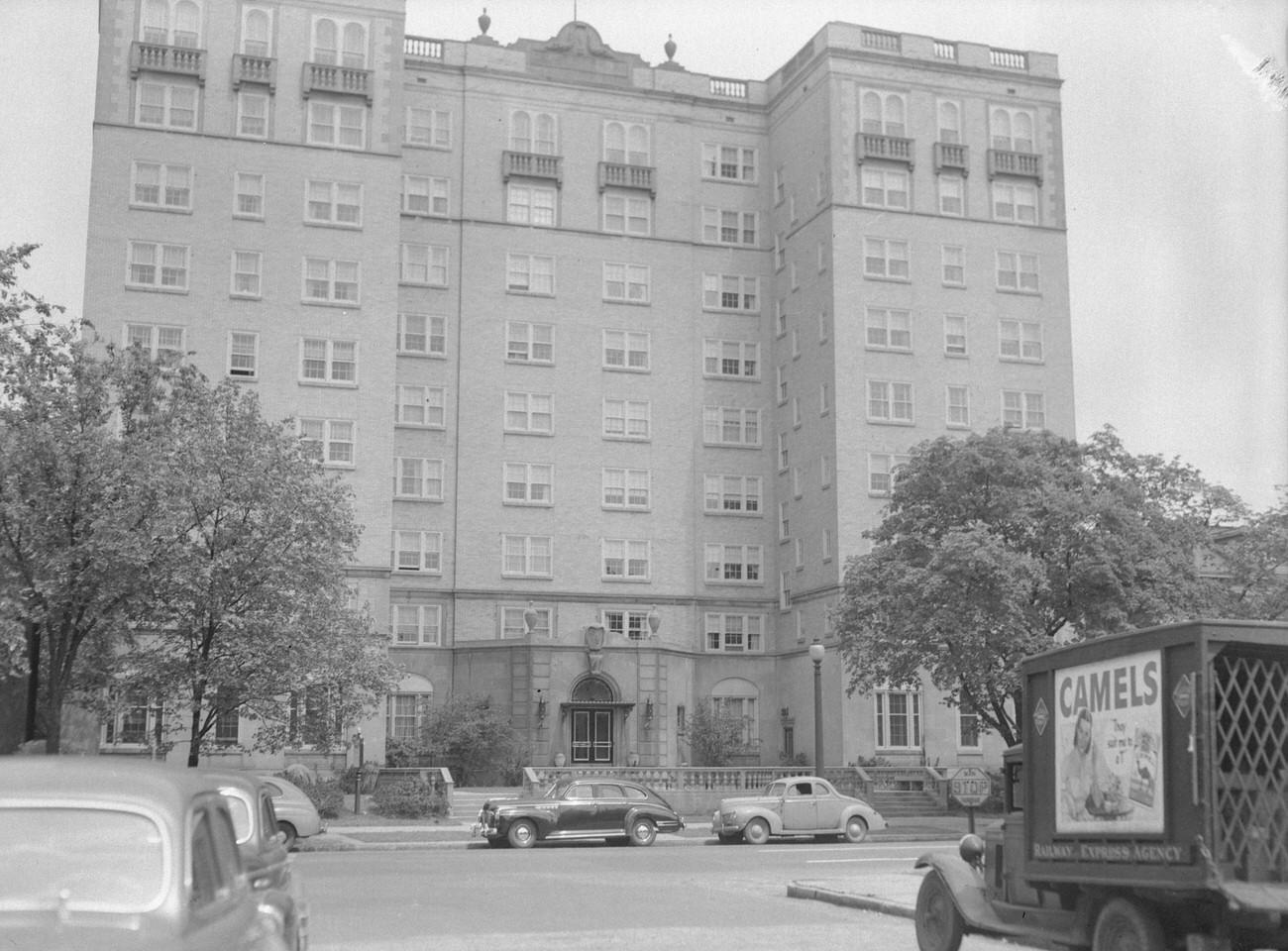 #12 Cambridge Arms Apartments, with Camel cigarette truck, built in 1928, listed on National Register of Historic Places in 1986 but removed in 1987, restored in 2005, Circa 1948.