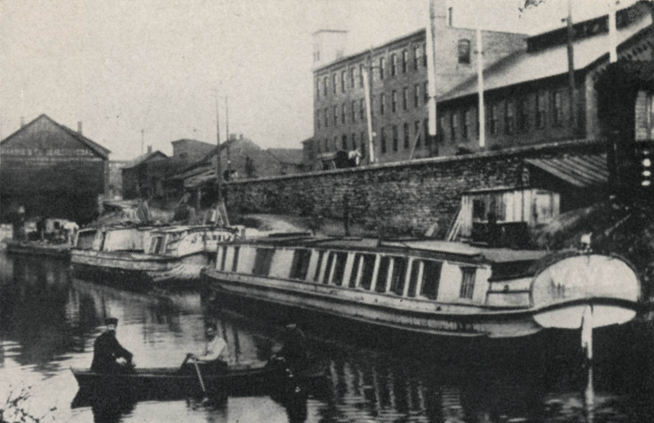 #20 Canal boats and warehouses near Main Street, Jackson-Guldan Violin Company in the background, 1954.