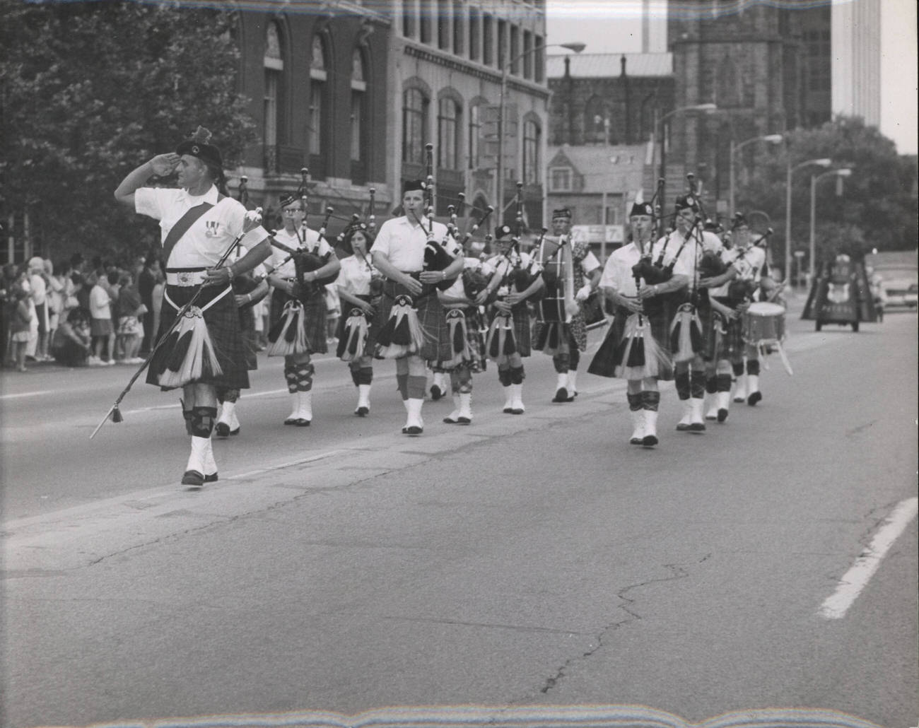 #15 Capital City Pipes and Drums with Drum Major David Breese in a parade in downtown Columbus, 1970s