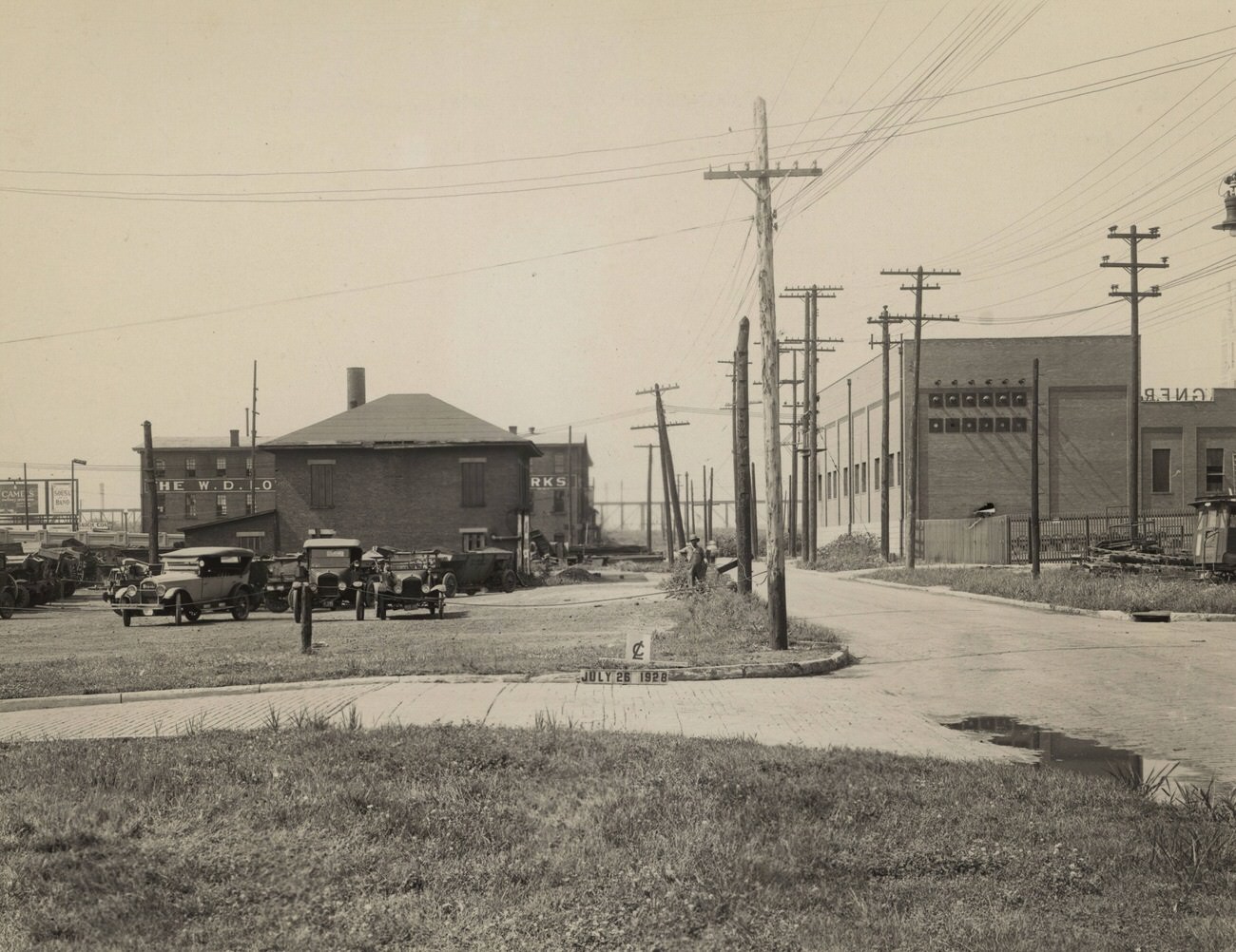 #18 City garage south of Mound Street and west of Short Street, featuring W. D. Lowe Machine & Engine Works and Wagner Awning Company, July 26, 1928.