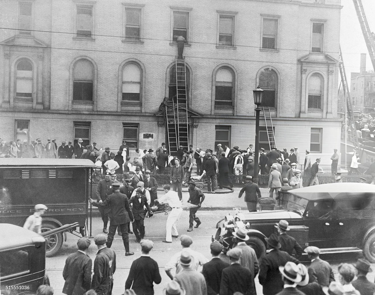 #30 Rescue workers retrieving victims of the Columbus, Ohio prison fire, where over three hundred convicts died, bodies loaded onto Army trucks for transport to a temporary morgue