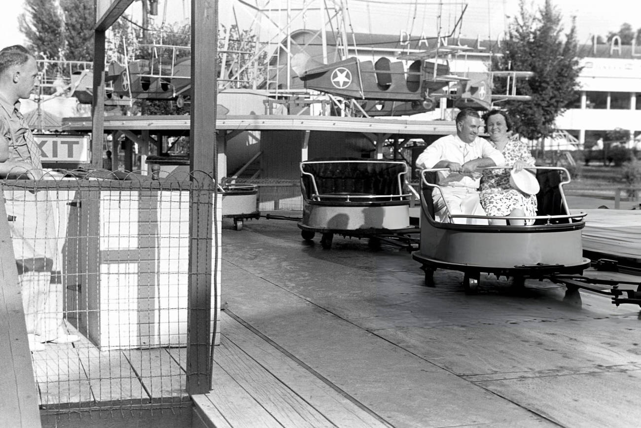#33 A couple enjoys a ride at Buckeye Lake Amusement Park near Columbus, Ohio, Summer 1938