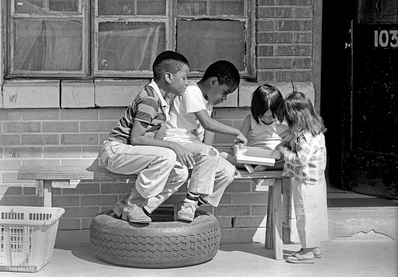 #7 Two African American boys play with two Asian immigrant girls, Houston, Texas, 1983.