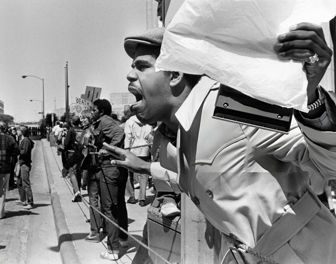 #55 Protesters and police during a Ku Klux Klan march in downtown Houston, Texas, 1983.
