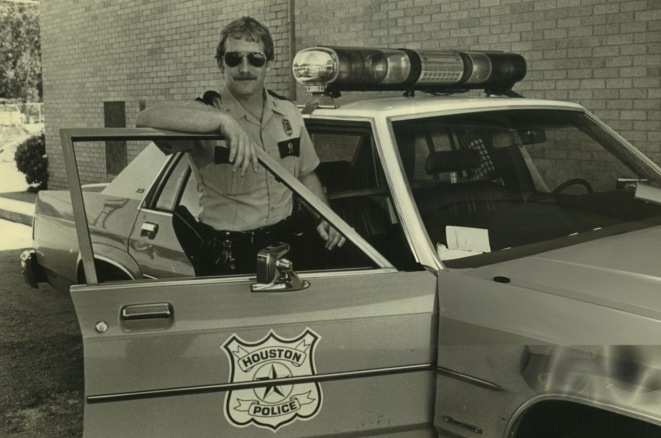 #56 Houston police officer T.J. Boyle aids motorists in trouble, Houston, Texas.