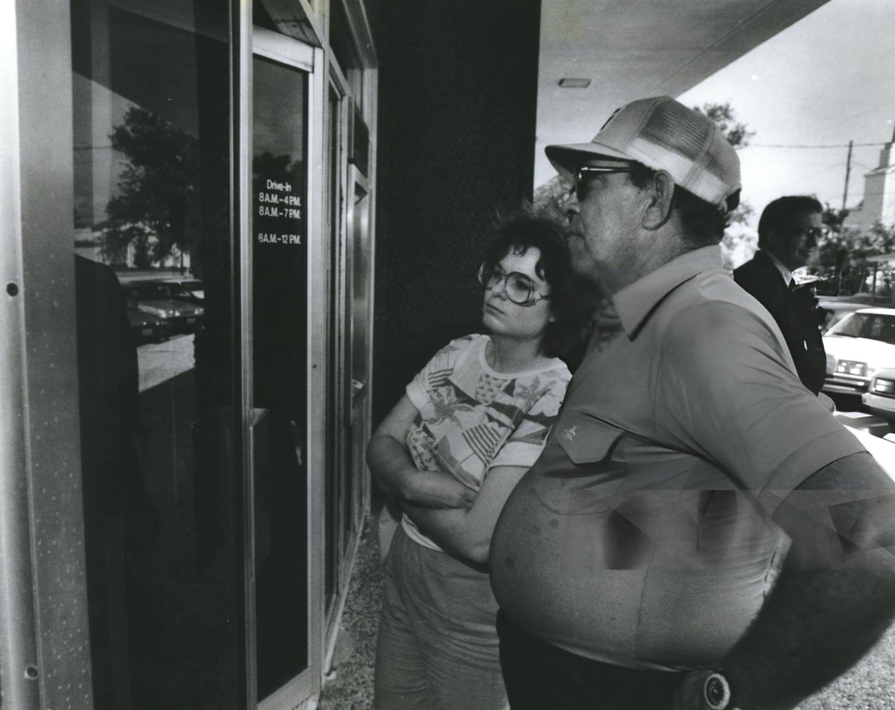 #85 Ruby Peek and Carlos Vivo read the insolvency notice on the door of Katy National Bank, Houston, 1980s
