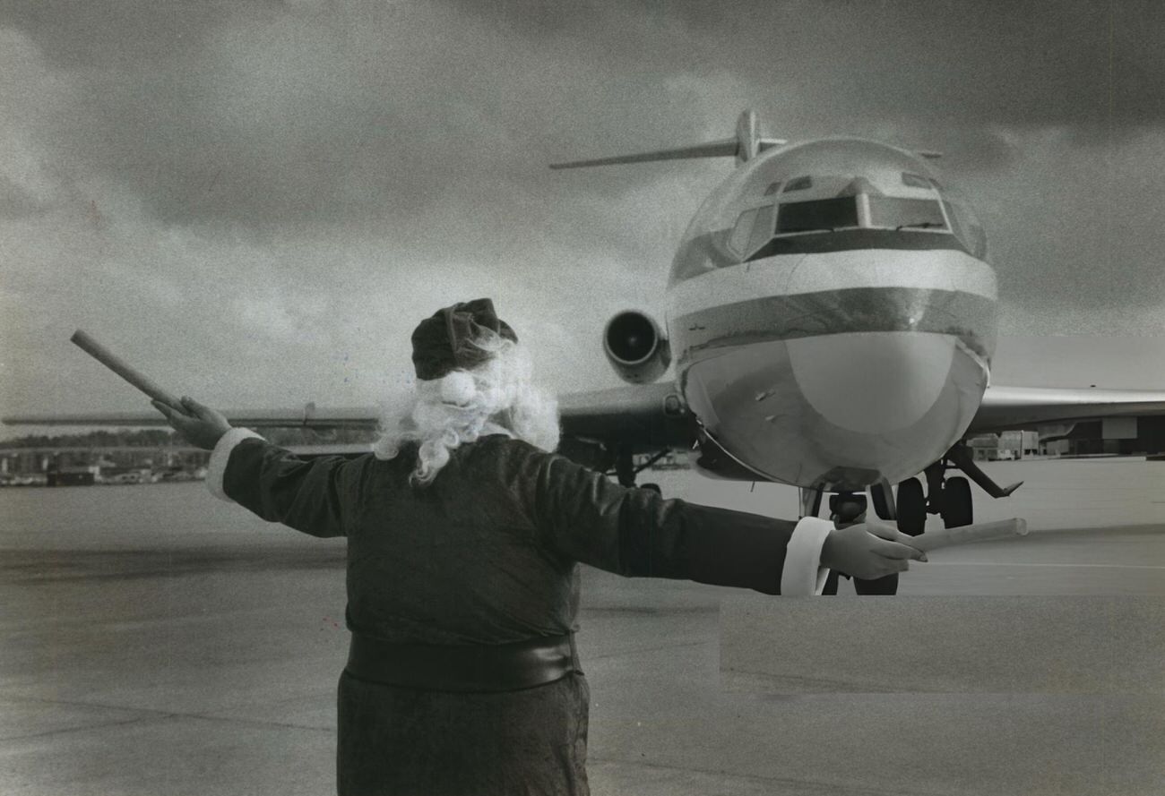 #30 George Bird, an American Airlines employee, dresses as Santa to help direct traffic at Houston Intercontinental Airport.