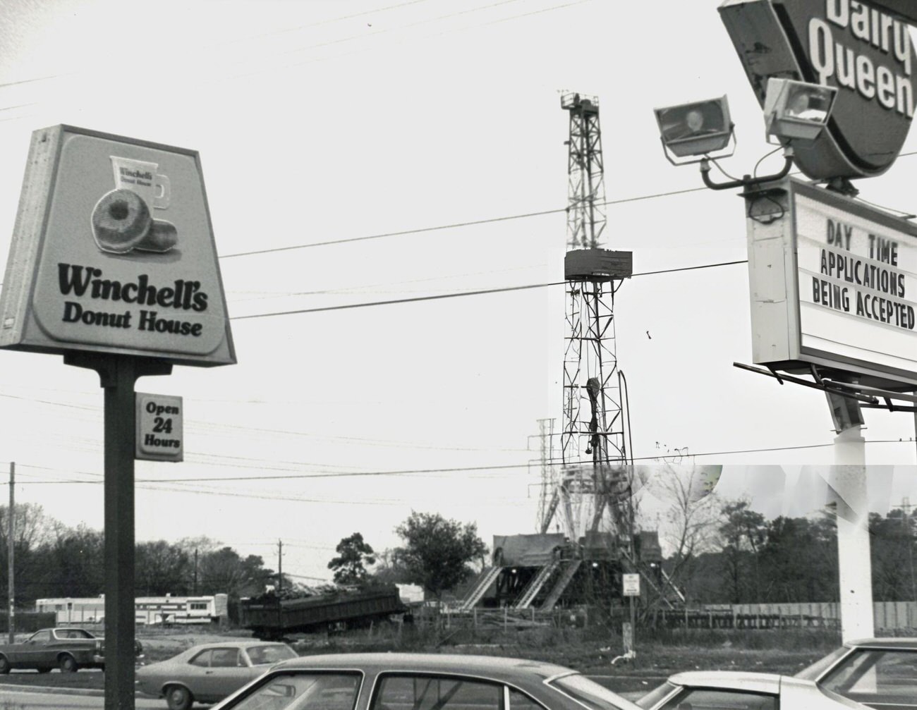 #32 A drilling rig towers above traffic and shops on 20th Street, Houston, Texas, February 7.
