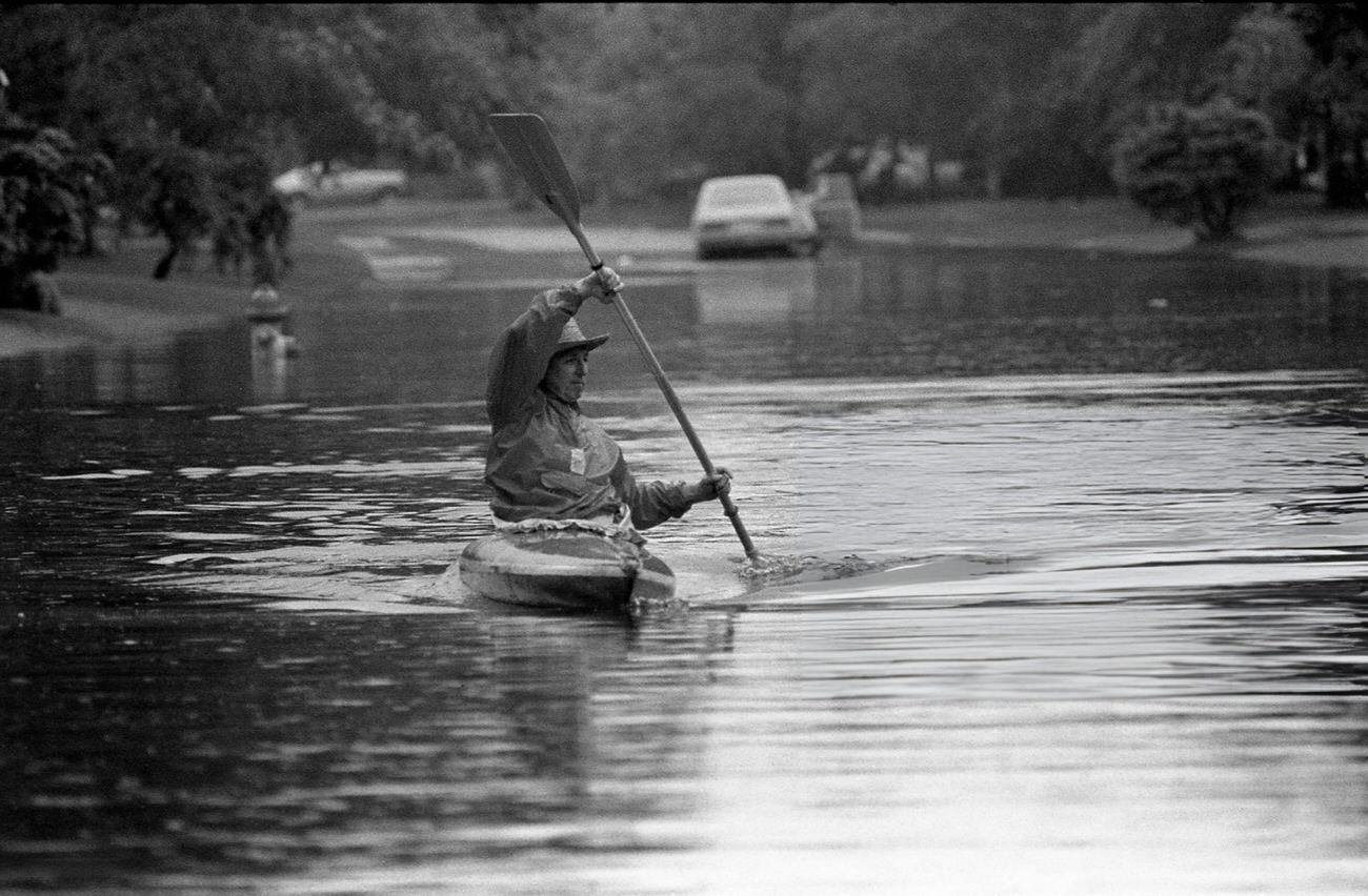 #34 Bob Olson uses a kayak on flooded Empress Drive near Edgebrook after heavy rains in Houston, Texas, May 3, 1981.