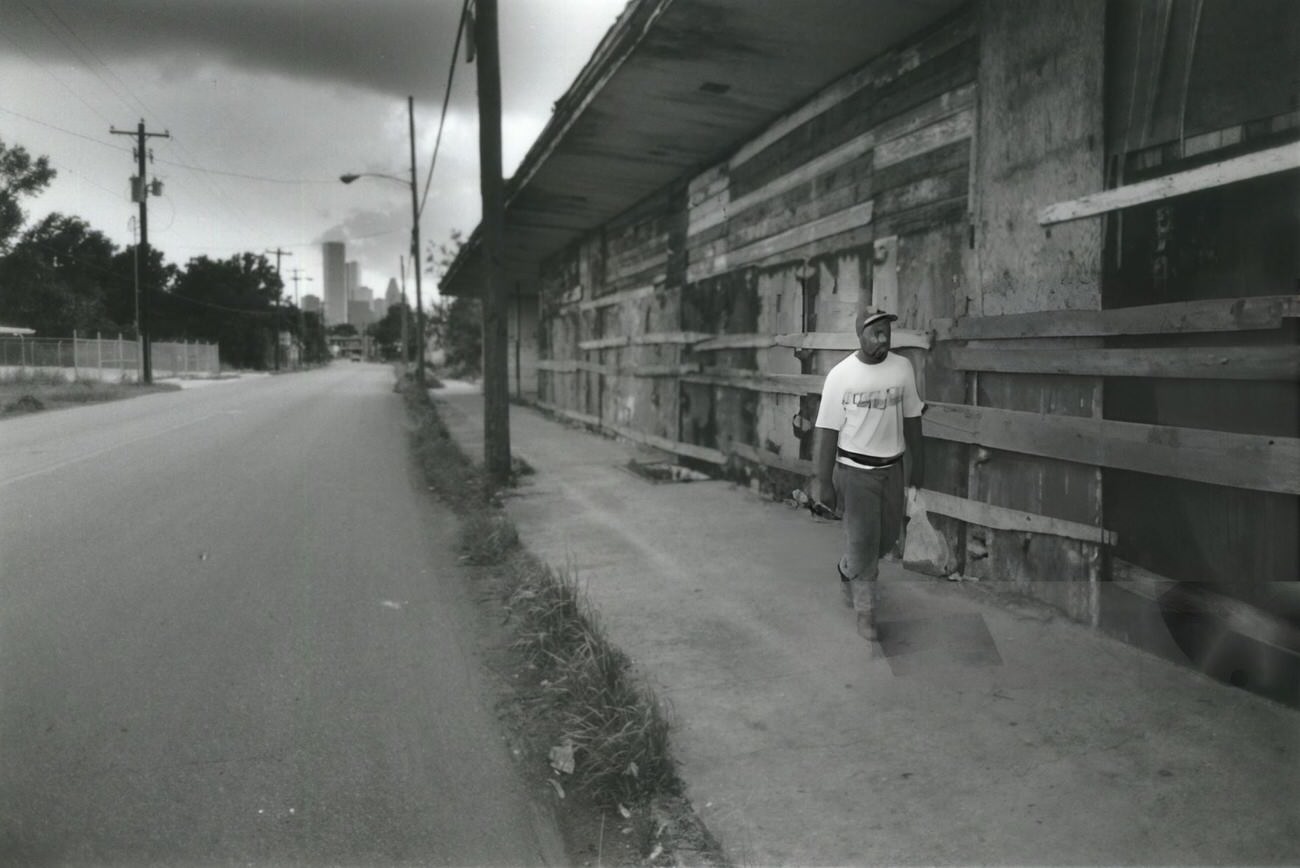 #2 Horace Wilson’s walk past boarded-up storefronts on Lyons Avenue illustrates the decline of once-vibrant business districts in Houston’s Fifth Ward.
