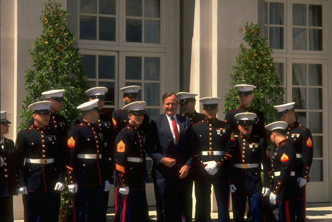 #36 President George H.W. Bush is flanked by his white-gloved honor guard marines during the Houston Economic Summit, Texas.
