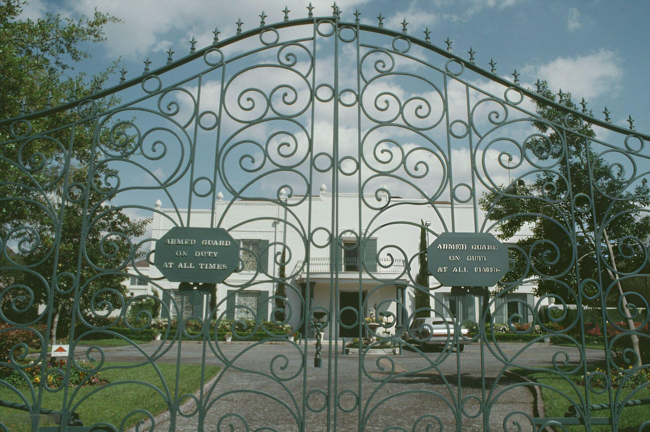 #18 The gate of a private residential building in April 1992 symbolizes the exclusivity and privacy valued in Houston’s residential architecture, Texas.