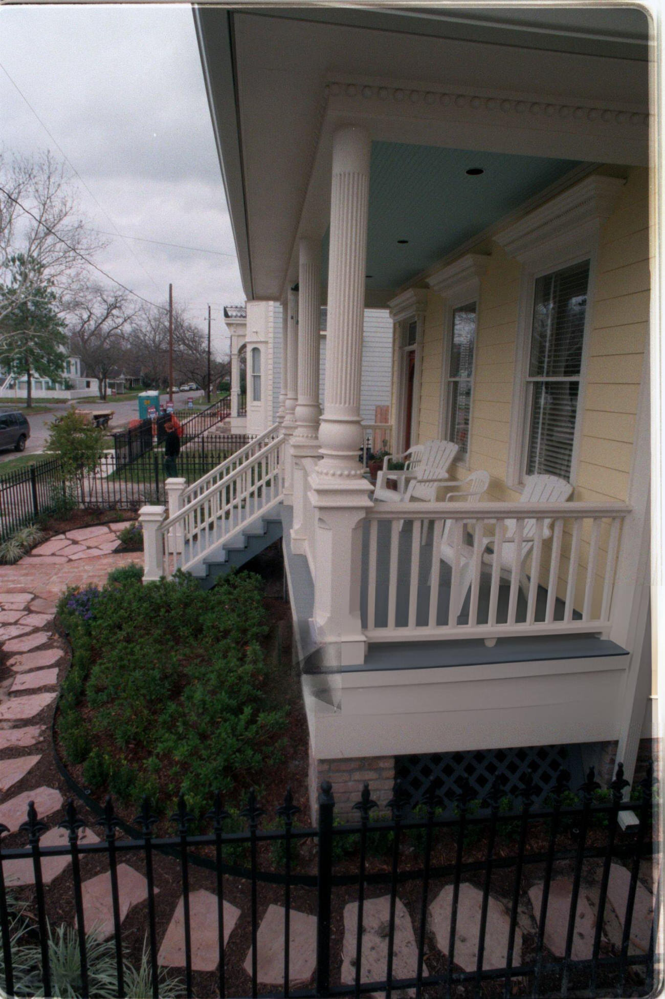 #59 Home construction showcases wicker furniture and iron fence in the Houston Heights with rising median prices, 1998.