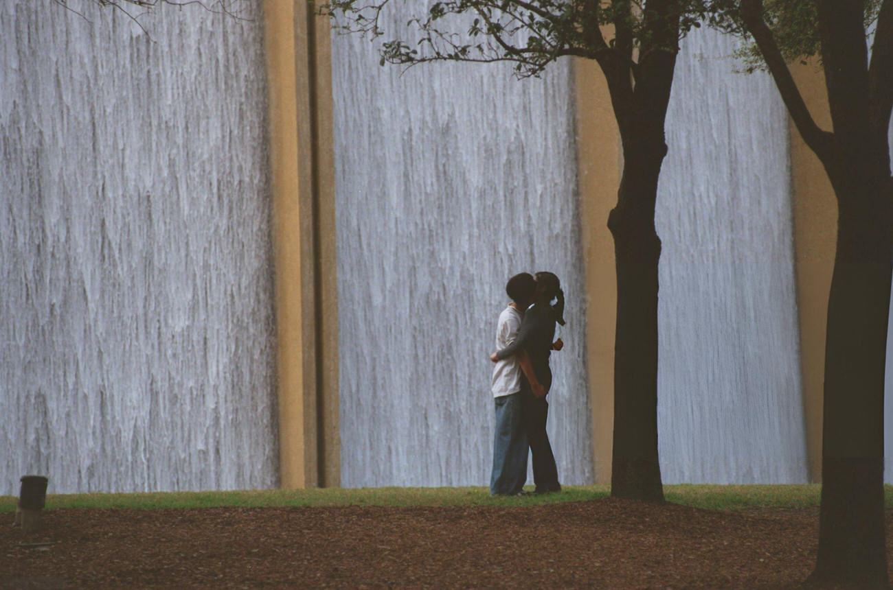 #23 Yvonne Lee and Michael Nguyen by the Transco Tower water wall, Houston, Texas, 1999.