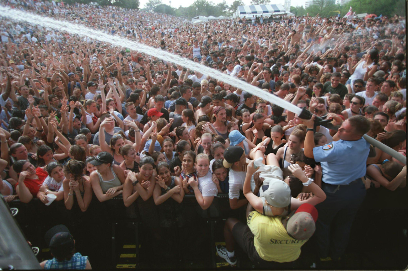 #25 Firefighter cools down crowds at the Earth Day Festival in Buffalo Bayou Park, Houston, Texas, 1999.