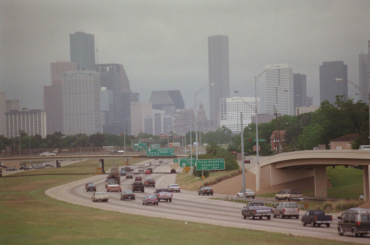 #63 Downtown Houston skyline obscured by smog, viewed from North MacGregor Way bridge, Houston, Texas.
