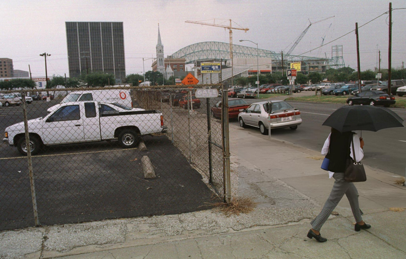 #10 Pedestrian walks past a future basketball/hockey arena site downtown, Houston, Texas, 1999.
