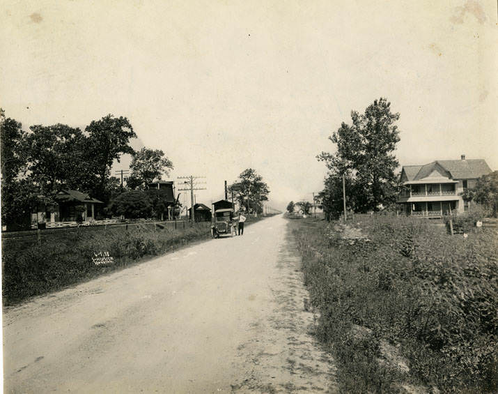 #58 Unimproved road with man and automobile, 1913.