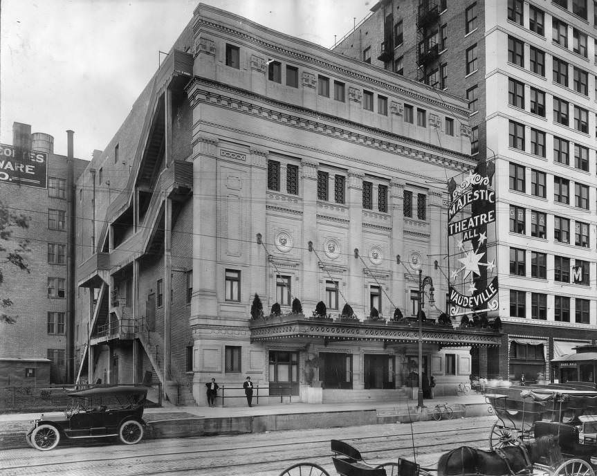 #63 Street view of Majestic Theatre, Houston, with streetcar tracks and horse-drawn carriages, 1910.