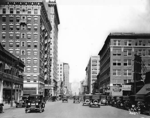 #111 800 block of Main Street with automobiles and Bender Hotel, Houston, 1920s