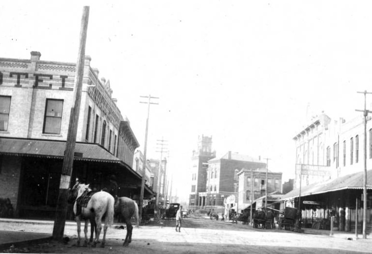 #30 Street view of buildings and horses, 1895
