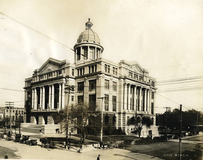 #54 New Harris County Courthouse with early automobiles and horse-drawn buggies, 1900s.