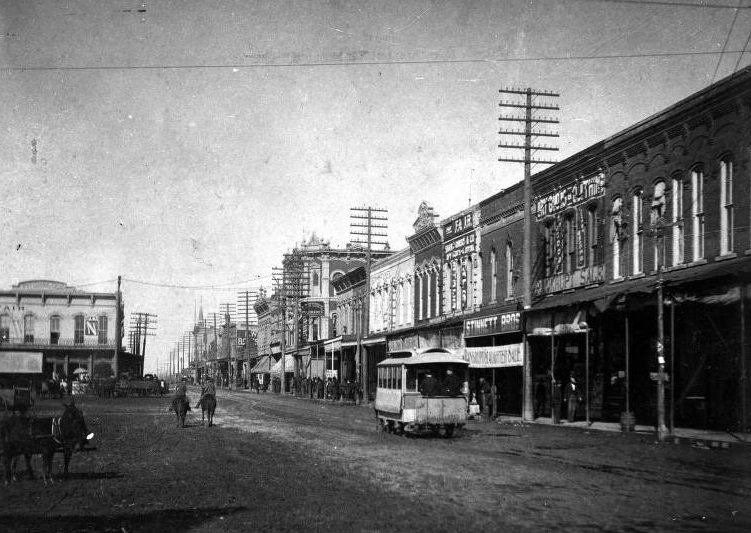 #36 Travis Street in Sherman with storefronts and cable car, 1897