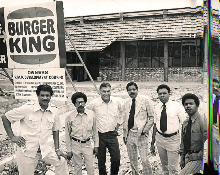 #47 Judson Robinson, Jr. with men at Burger King site, 1970s