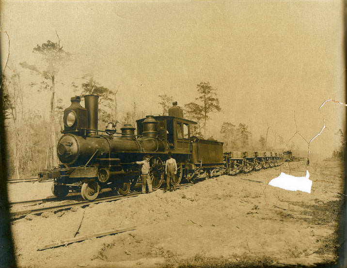 #2 Two men beside railroad freight train engine, 1880s
