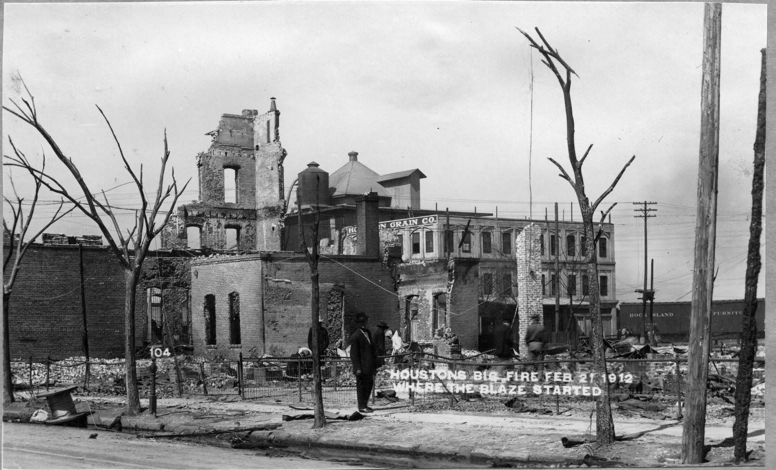 #32 People inspecting fire damage, February 21, 1912.