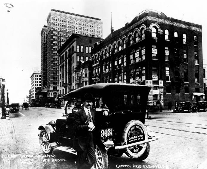 #38 Frank J. Schlueter, photographer, beside automobile, Houston, 1920s