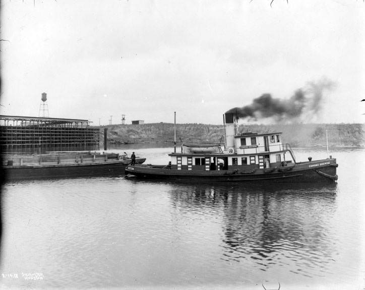 #75 Tugboat pulling a barge, 1920s