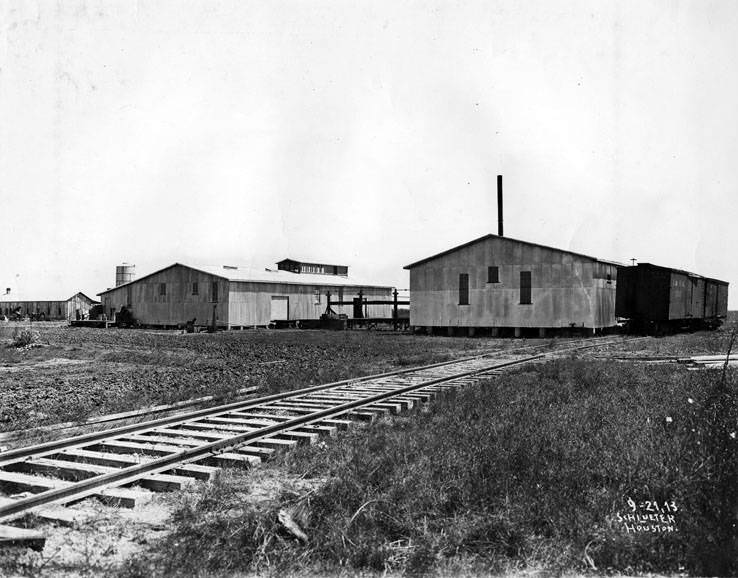 #91 Buildings among railroad tracks, 1923.
