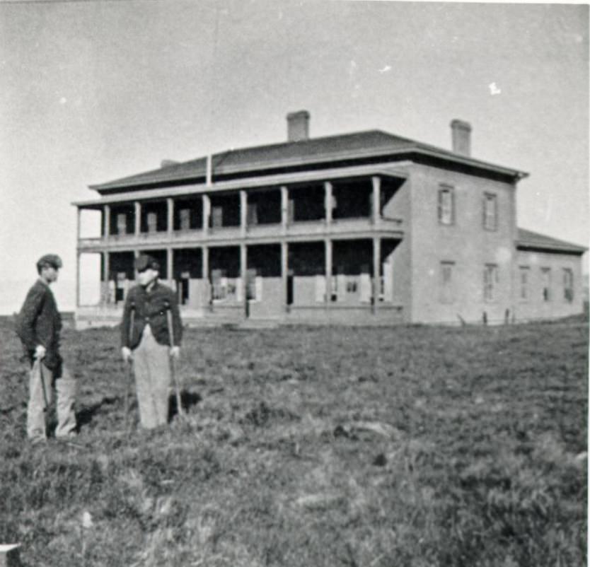 #17 Two men standing outside the Presidio Hospital, 1867